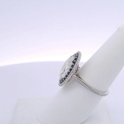 5.01CTW OVAL DIAMOND CUT & 0.63CTW SAPPHIRE RING