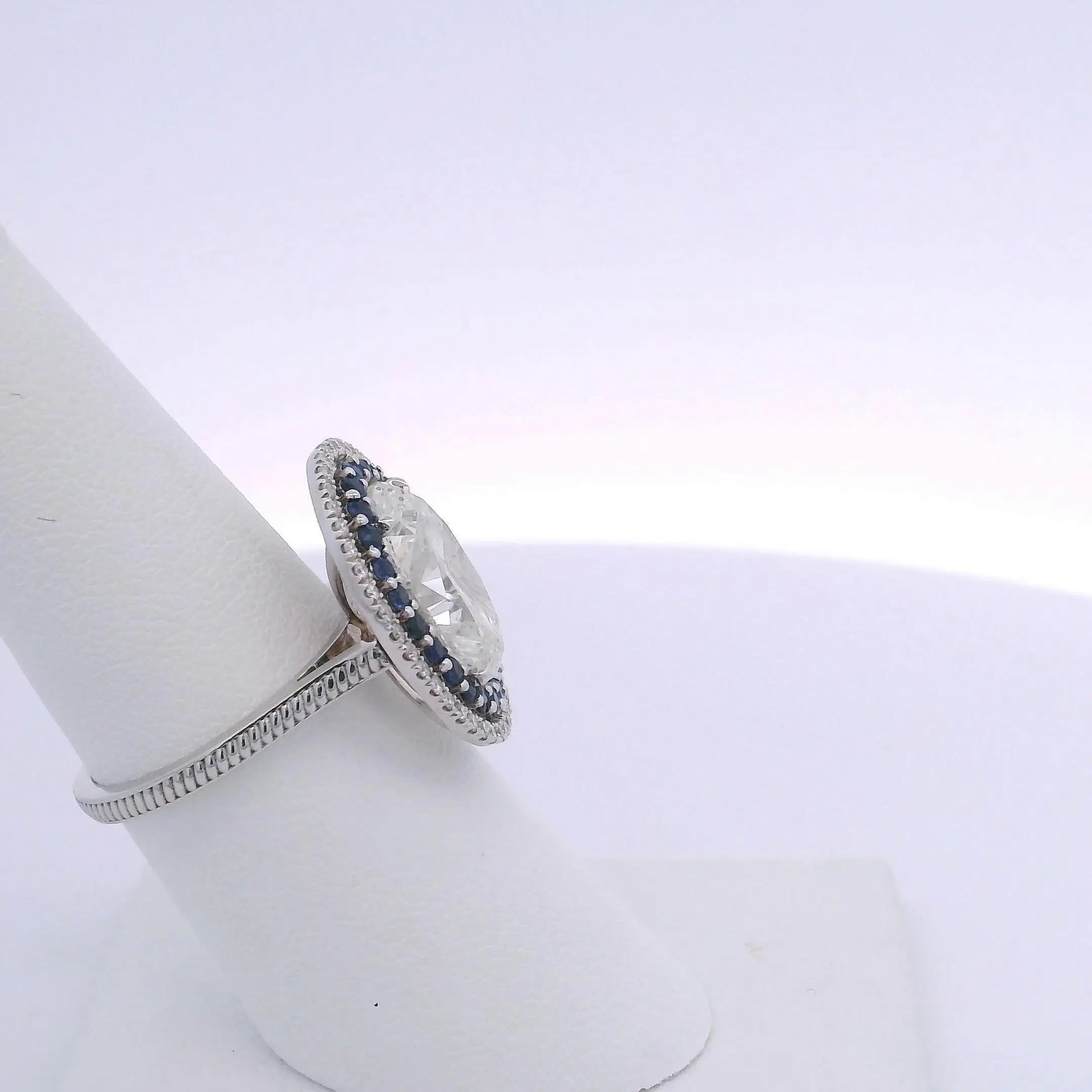 5.01CTW OVAL DIAMOND CUT & 0.63CTW SAPPHIRE RING