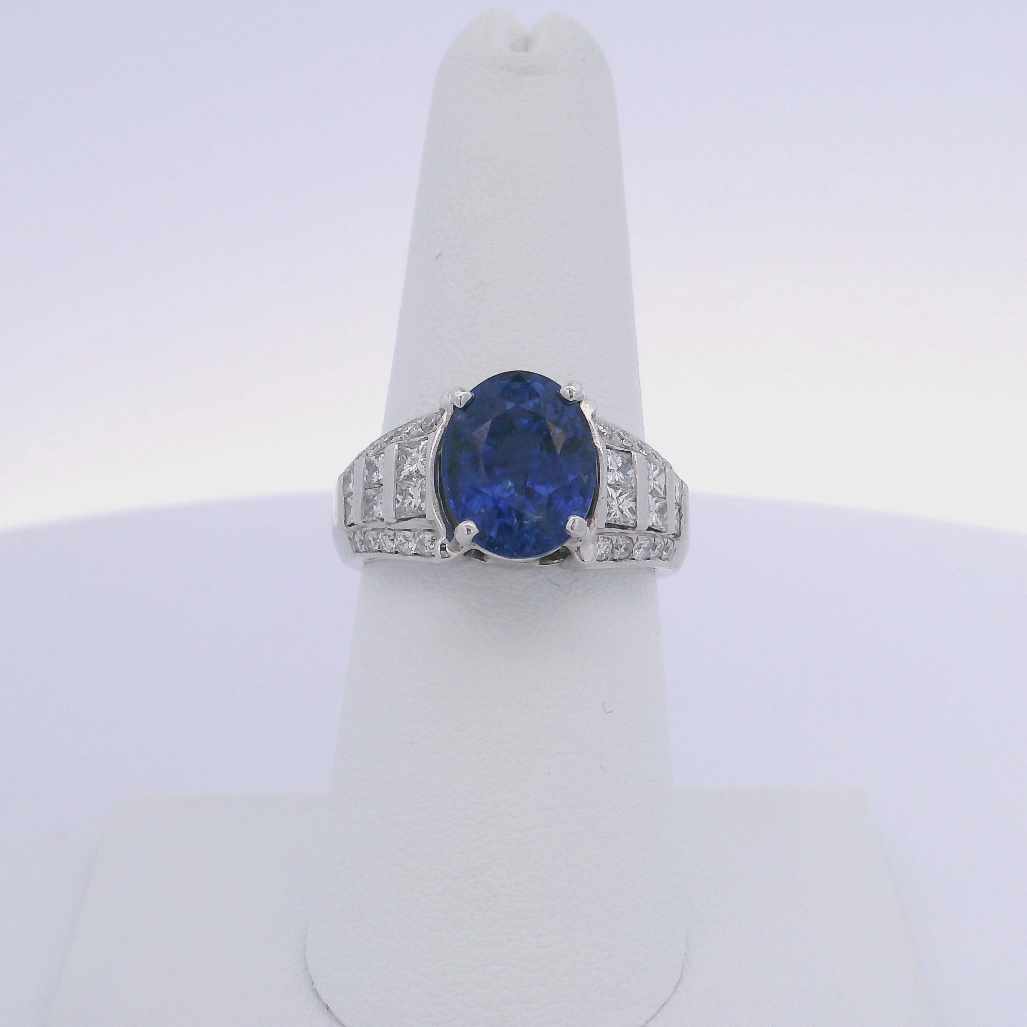 5.08CTW OVAL CUT SAPPHIRE 1.00CTW PRINCESS & ROUND BRILLIANT CUT DIAMOND RING