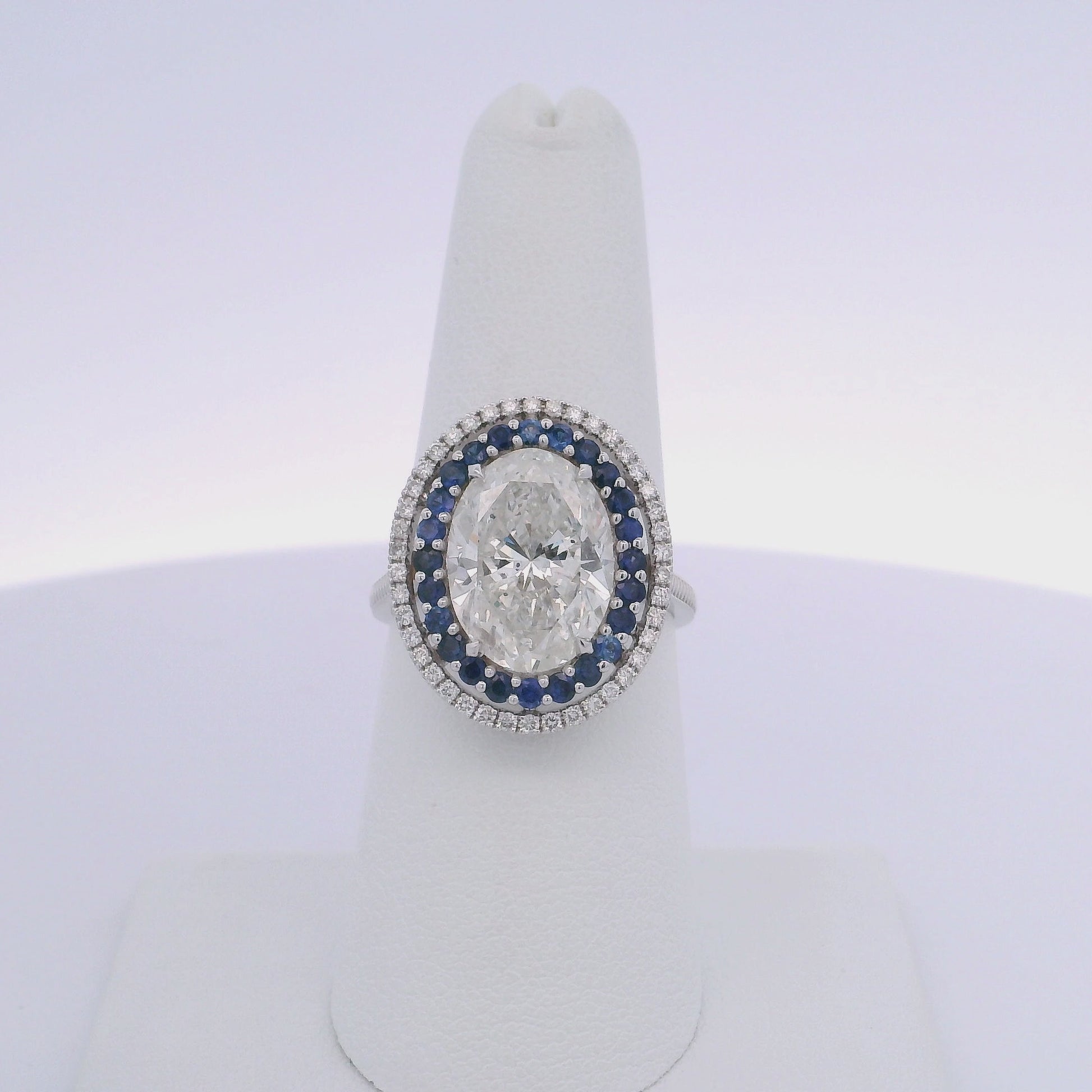 5.01CTW OVAL DIAMOND CUT & 0.63CTW SAPPHIRE RING