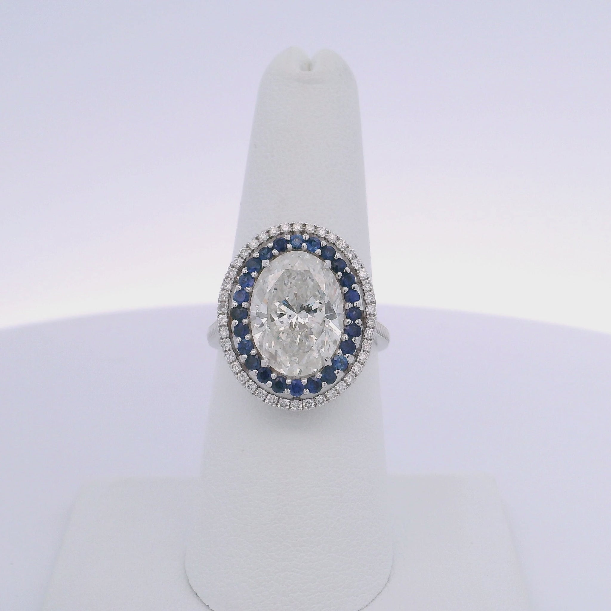 5.01CTW OVAL DIAMOND CUT & 0.63CTW SAPPHIRE RING